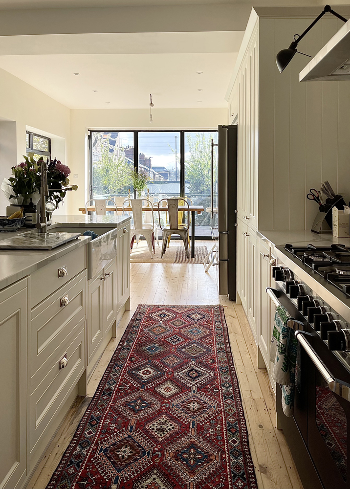 Neutral kitchen decorated in Lick Beige 02 paint shade with a rug