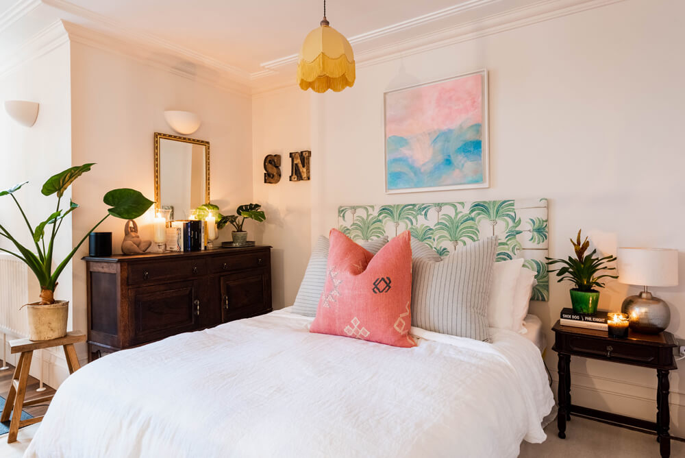 Upholstered palm print headboard in Tash's bedroom decorated in Lick Pink 01 paint shade