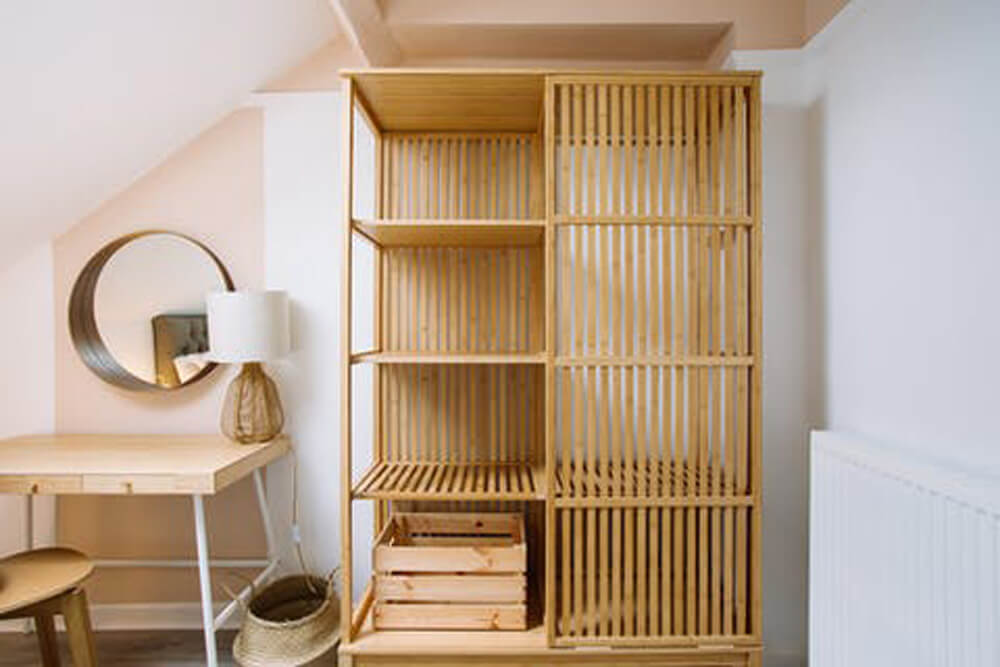 Bedroom with warm wood furniture and Pink 02 paint on the walls