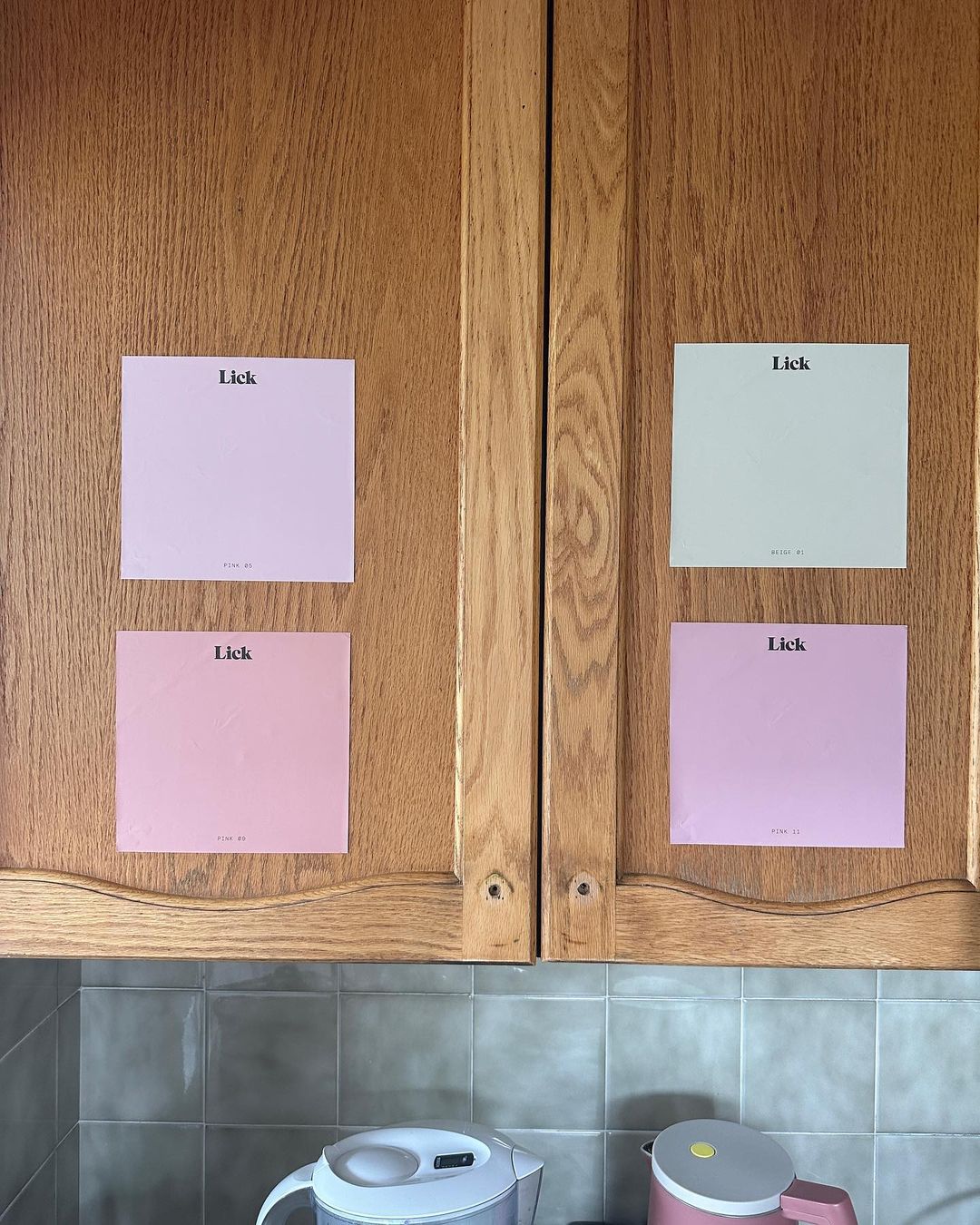 Kitchen cabinets with Lick pink samples on
