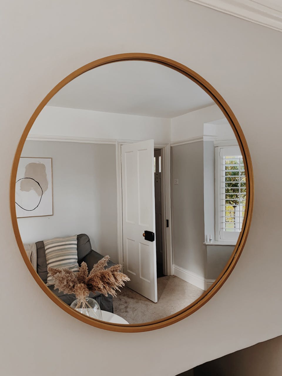 Living room decorated in grey 01 with a large mirror by @thevictorian.home