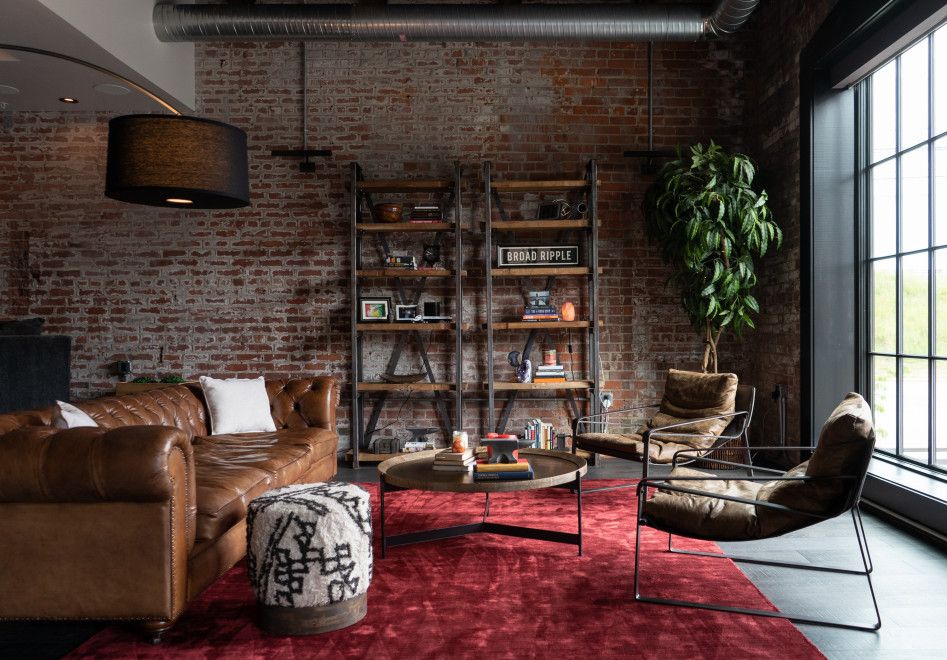 Living room with red rug and brown couch
