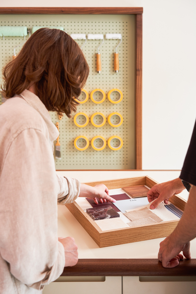 Woman playing around with Lick paint samples on a moodboard in Lick's Northcote 65 store