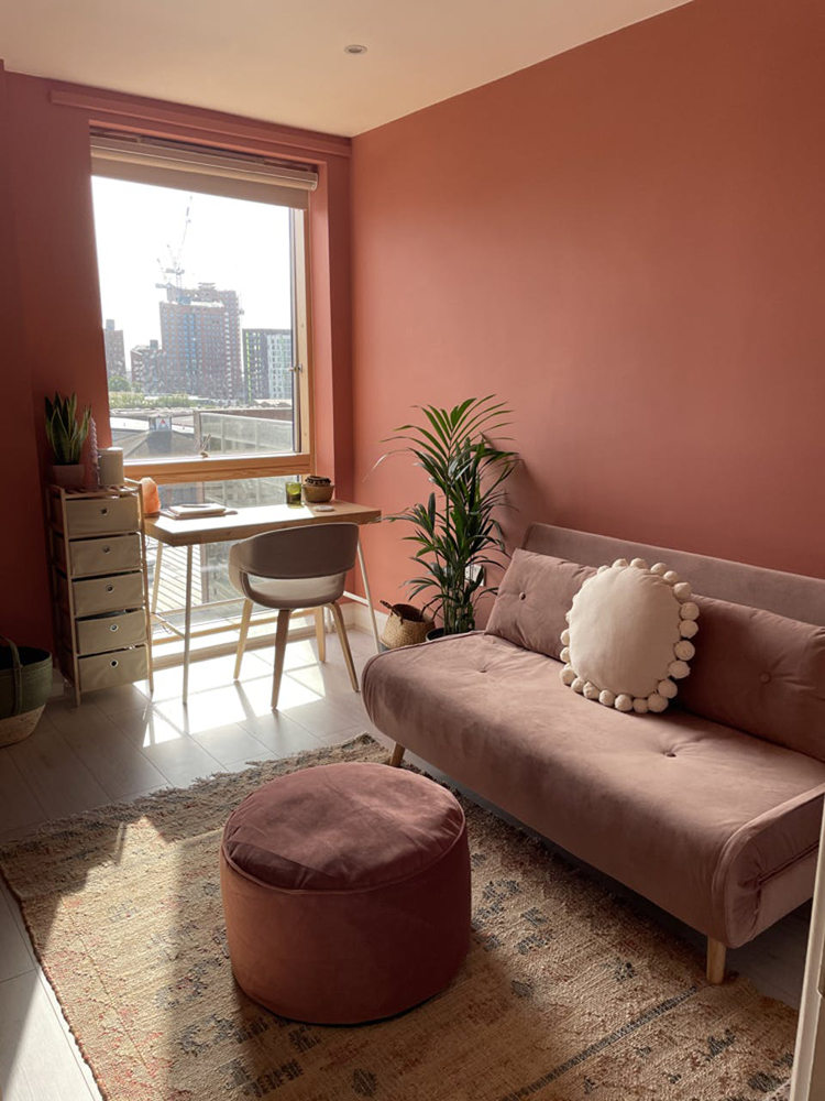 A bohemian living room painted in Lick Red 03 paint