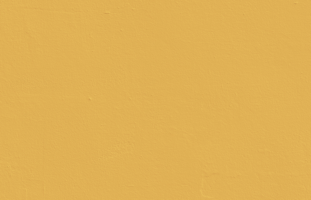 Textured wall decorated in Lick Yellow 03 paint shade