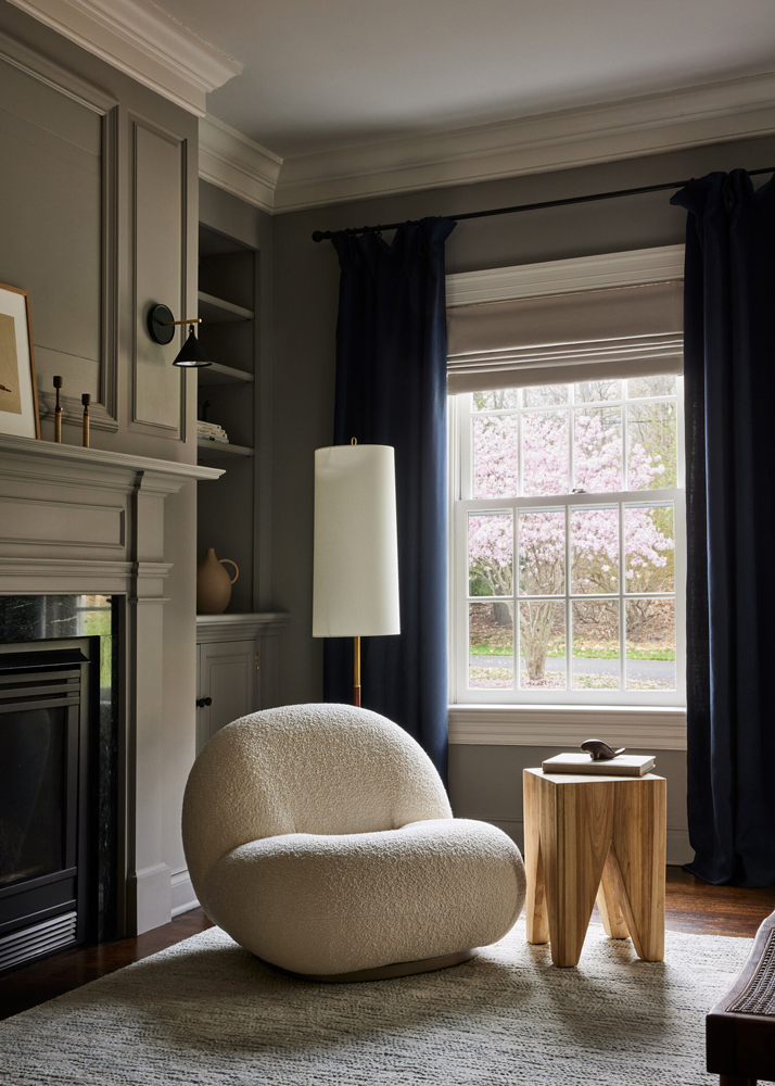 A transitional living room with a boucle chair in it