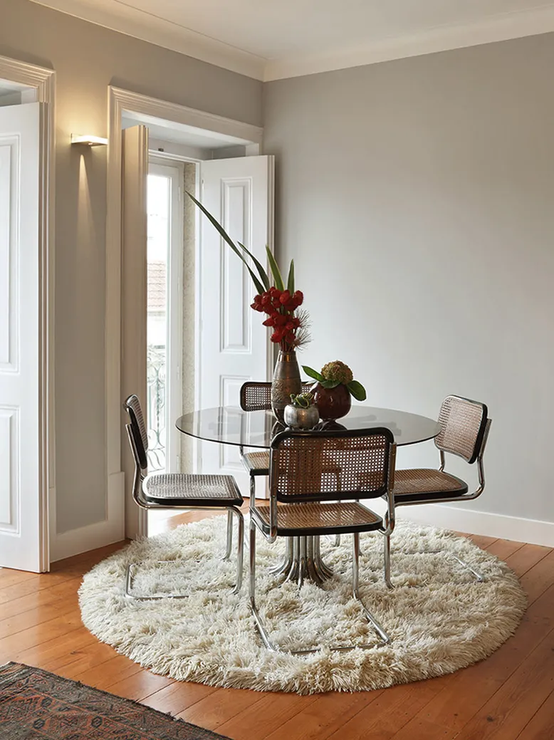 Interior trends contemporary dining room with white fluffy rug and rattan chairs