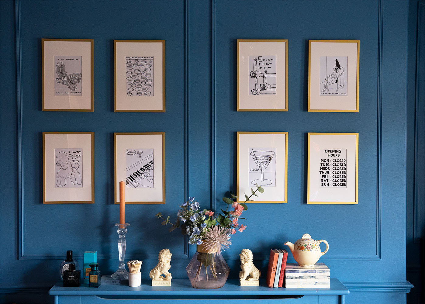 Jack D. March's gallery wall pops against the Blue 05 painted walls