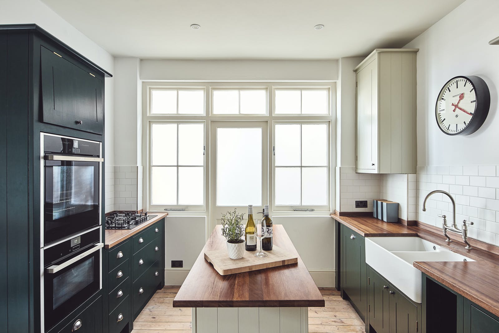 Kitchen with kitchen island painted in Lick Green 06 and Greige 02
