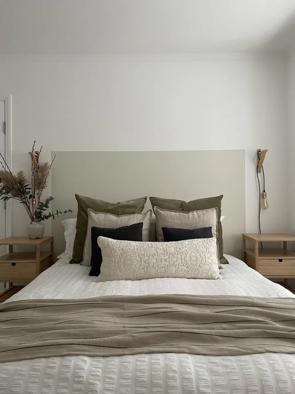 Rectangular painted DIY headboard in a bedroom decorated in Lick White 05 paint shade