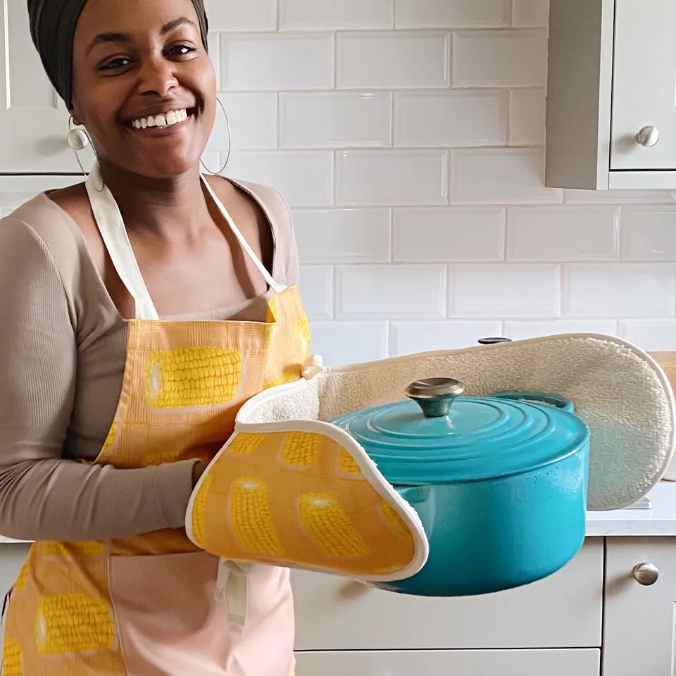 Woman wearing a yellow apron and oven gloves from Bonita Ivie Prints