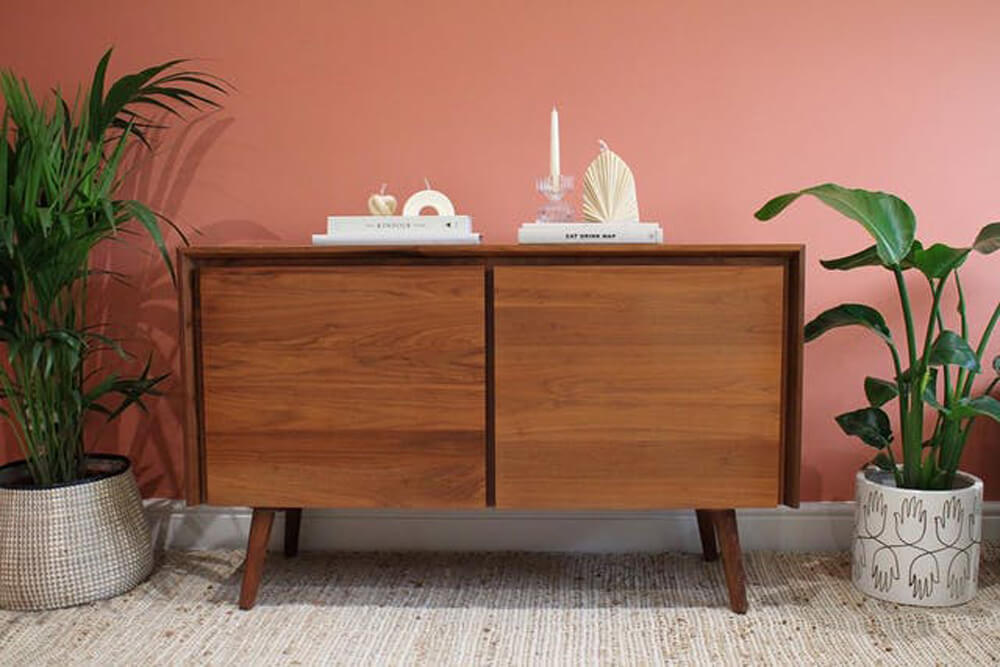 Mid-century modern console in a living room painted in Lick Red 03 paint