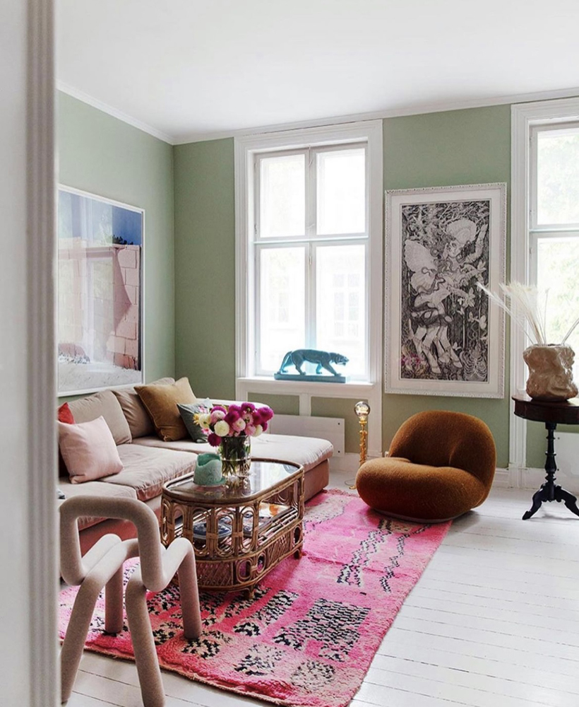 Erica Mathiesen's eclectic living room with green painted wall and colourful furniture 