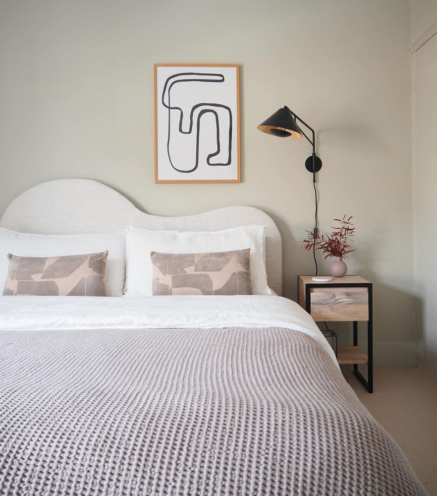 Minimalist Japandi style bedroom with a curved headboard and walls painted in Lick beige paint