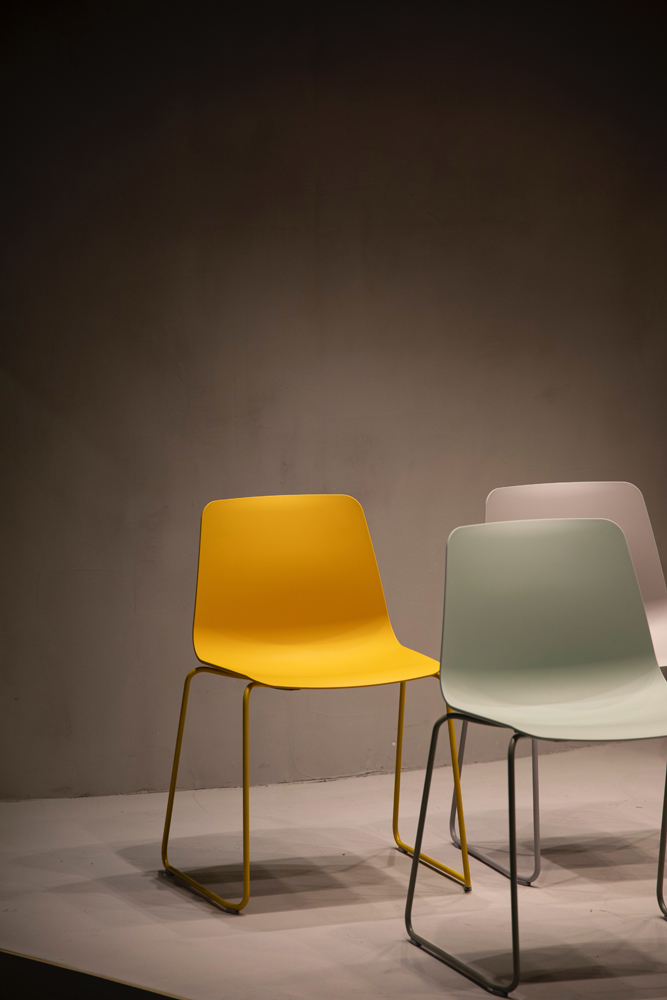 Modern chairs in yellow, grey and pink colours