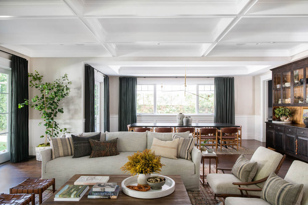 Modern farmhouse open living room space decorated with plants and flowers by Amber Interior Design