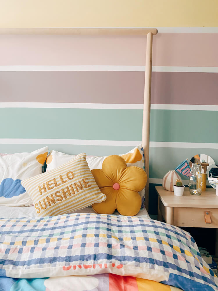 Rainbow-effect headboard painted in multiple Lick paint colours