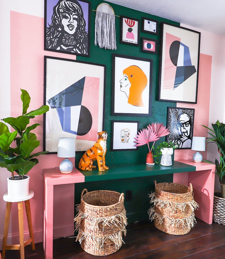 Pink and green hallway with funky gallery wall 