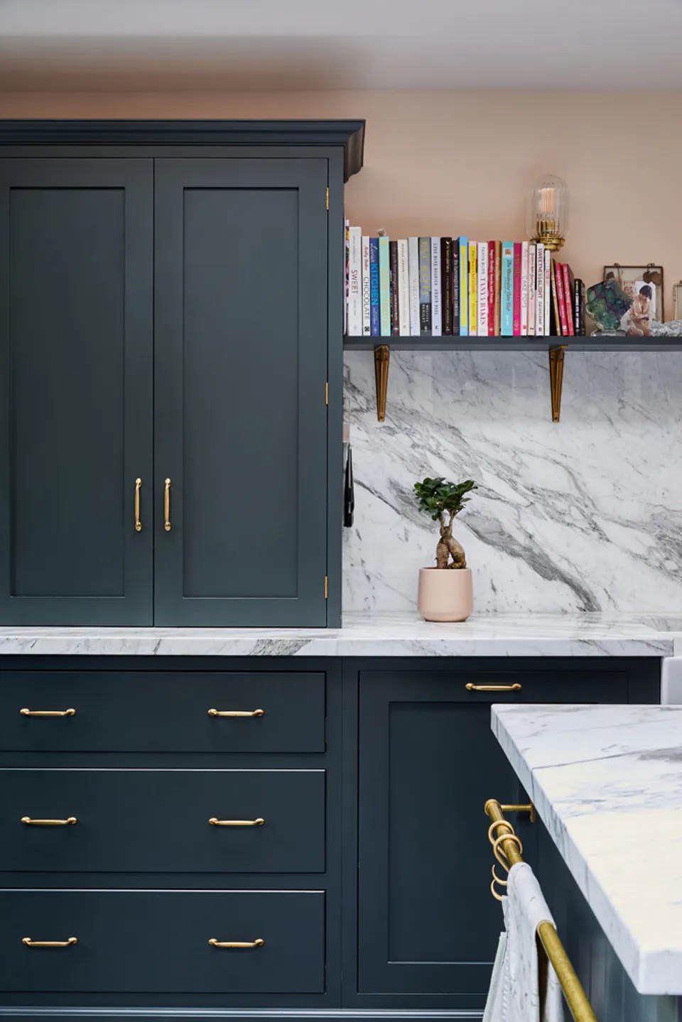 Black-painted kitchen cabinets in Daisy Lowe's kitchen decorated in Lick Pink 02 paint shade