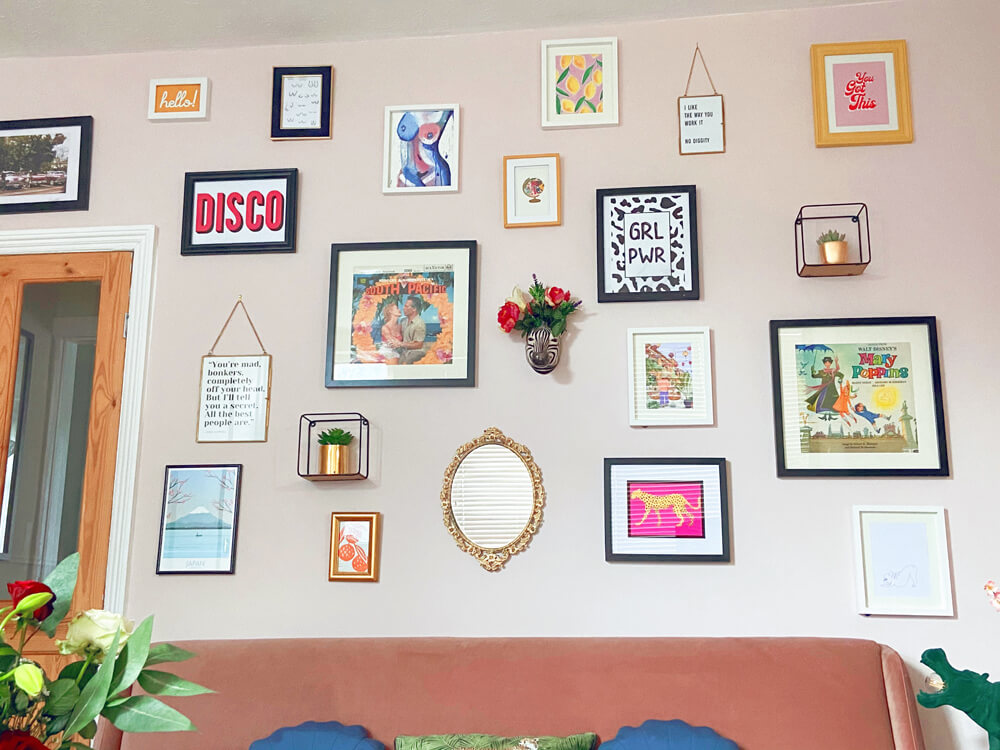 Living room gallery wall with mirrors and art prints walls painted in Lick paint Pink 04