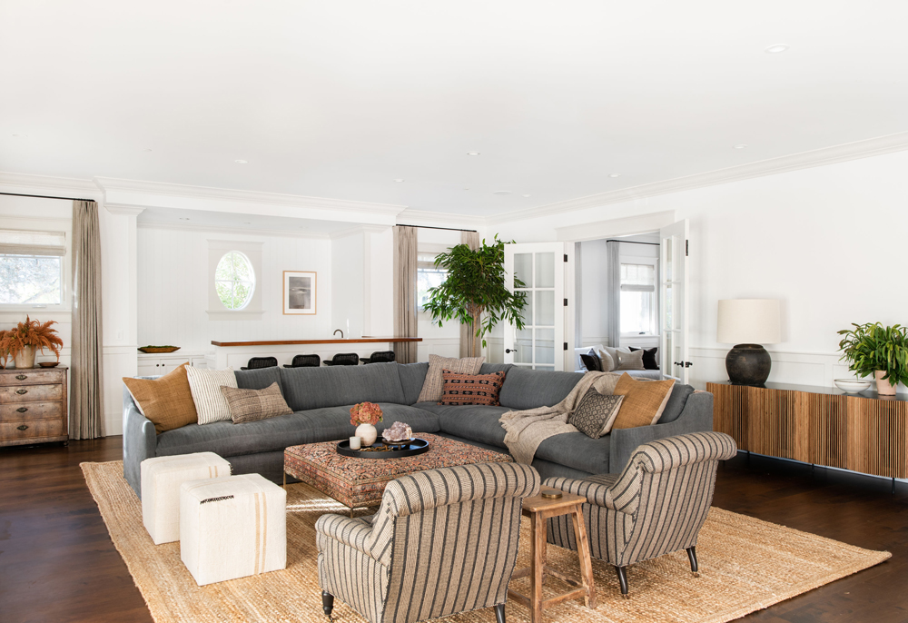 Modern farmhouse living room with an oversized rug and grey furniture via Amber Interior Design