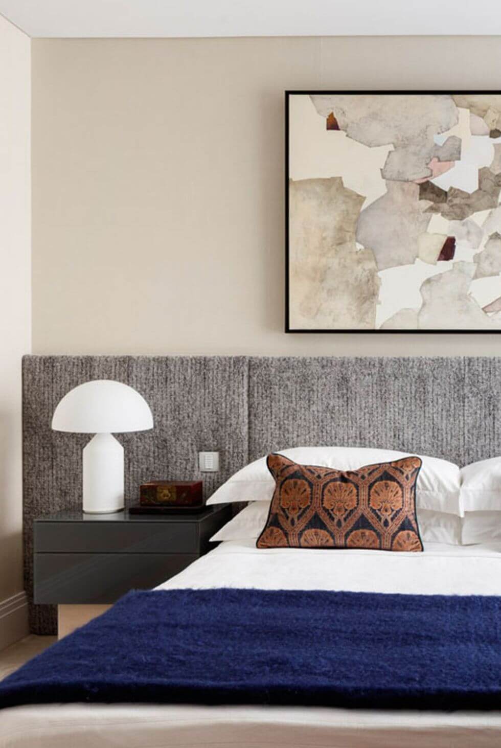 Bedroom with grey abstract art on wall