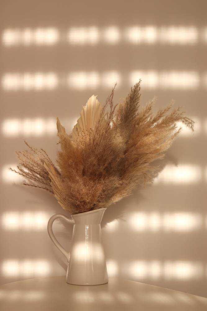 Dried flowers in metal vase