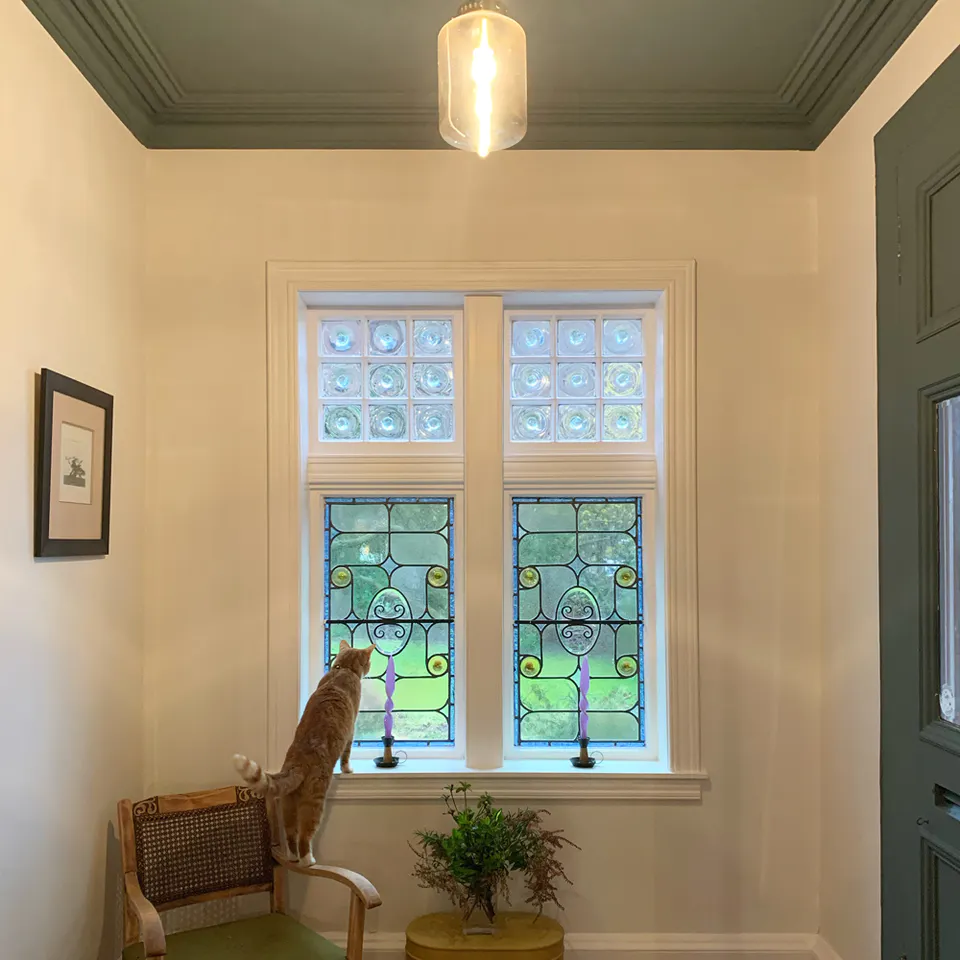 Hallway with stained glass window door and ceiling painted in Lick paint Green 03