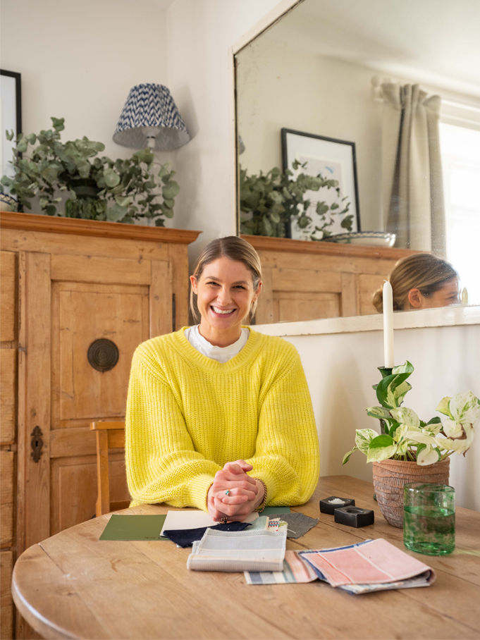 Portrait of Tash Bradley wearing a yellow jumper