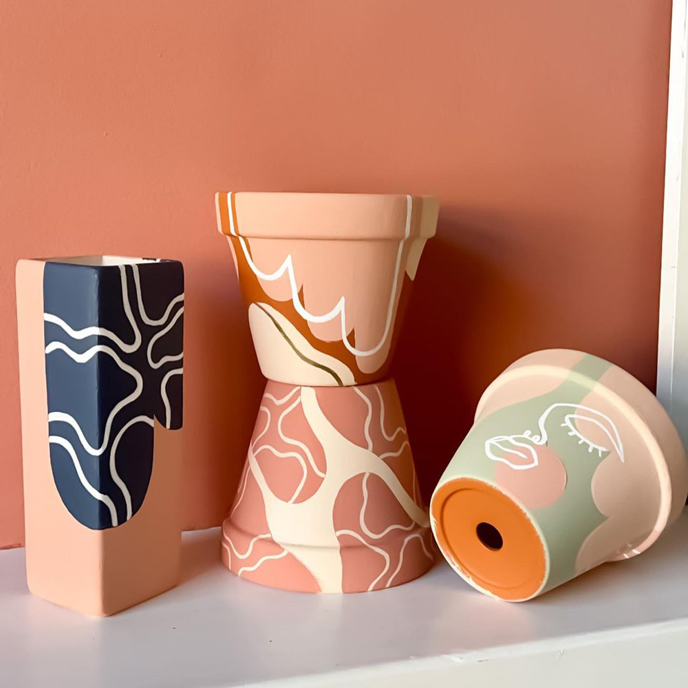 Crafted pots against a Red 03 Lick painted background