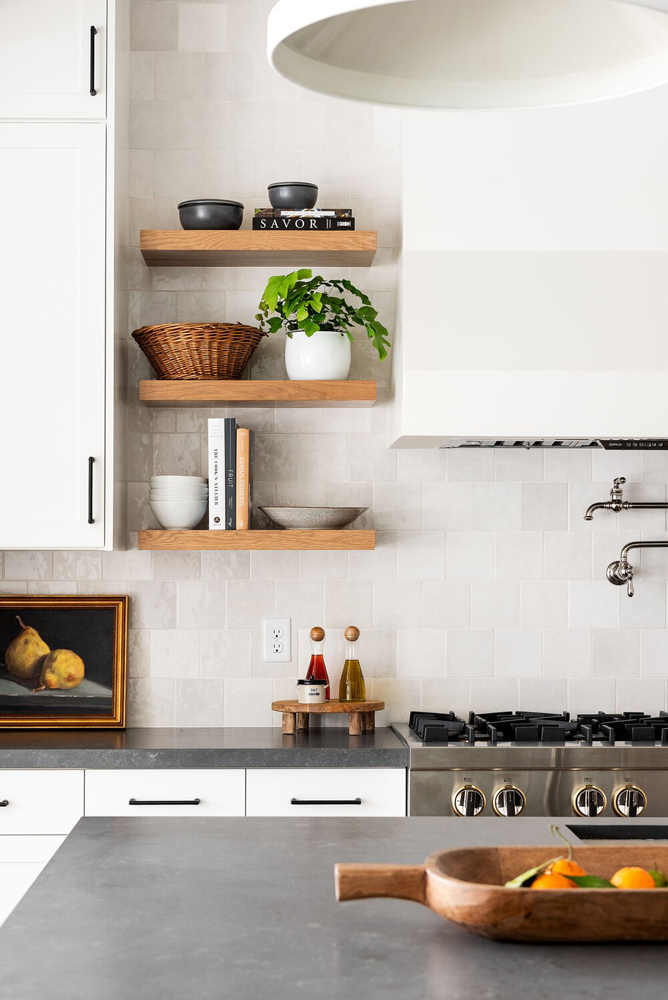 Modern farmhouse kitchen shelving decorated with books and potted plants via Studio McGee