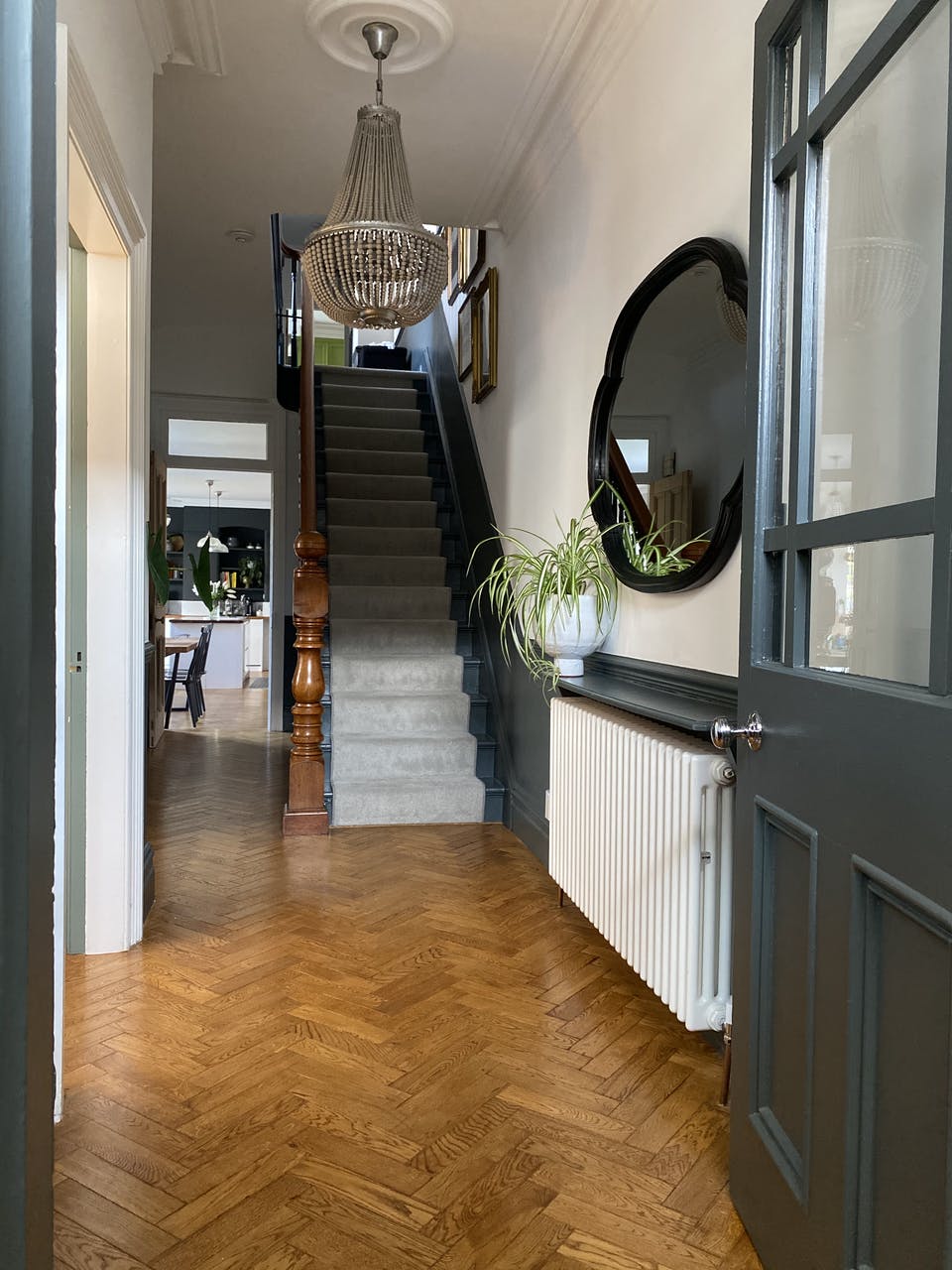 Front door view of hallway with herringbone flooring