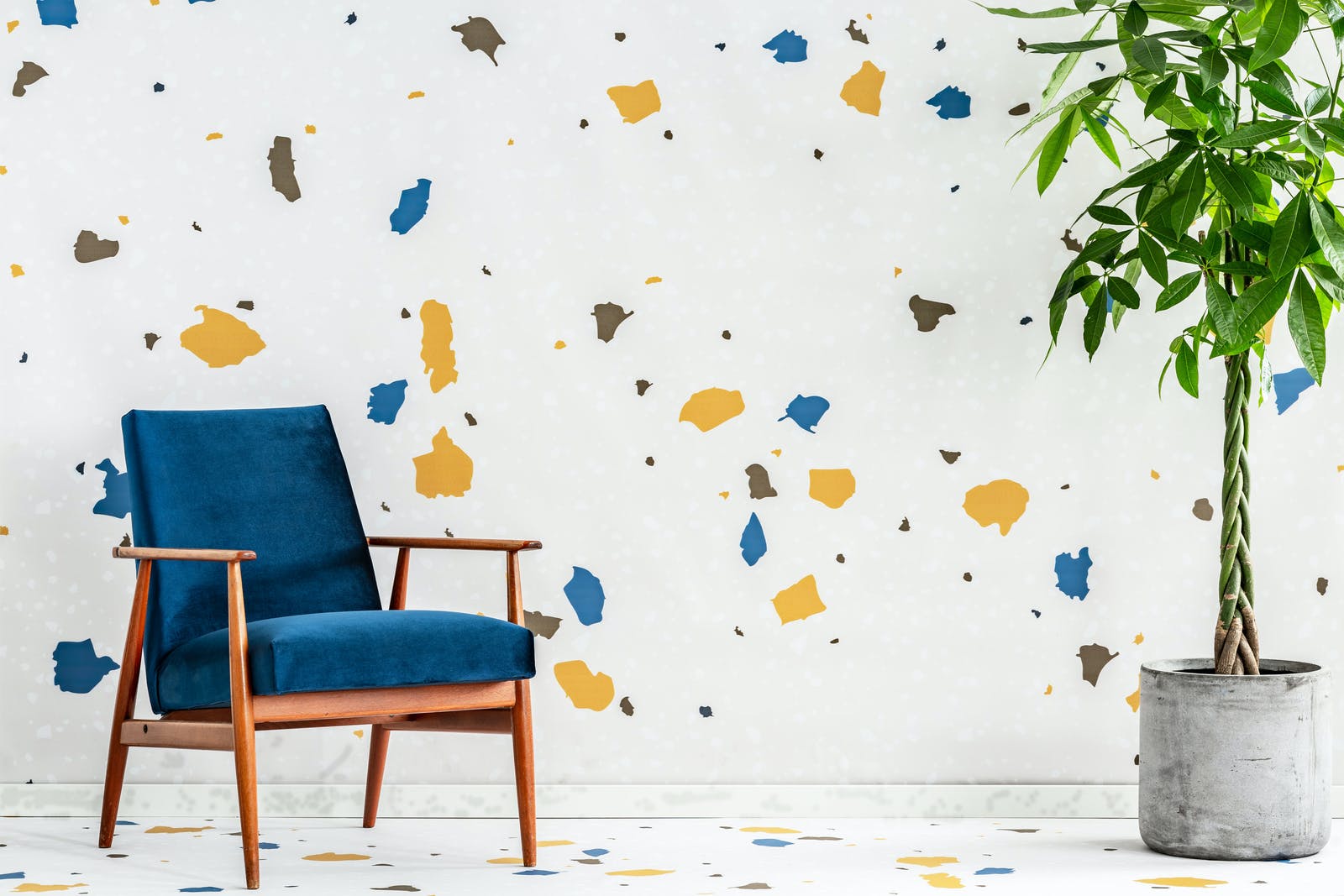 Blue chair in room with patterned wallpaper and floors