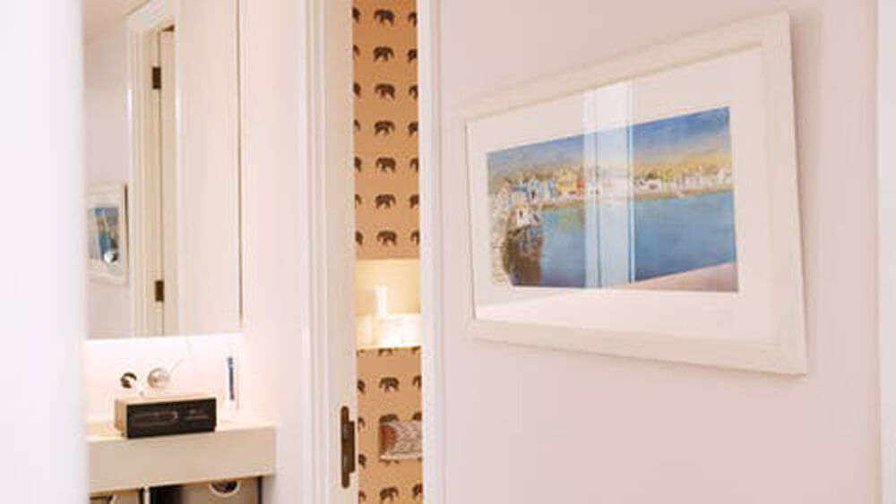 Vogue Williams' bathroom painted in Lick Pink 04 paint and Animal 04 wallpaper