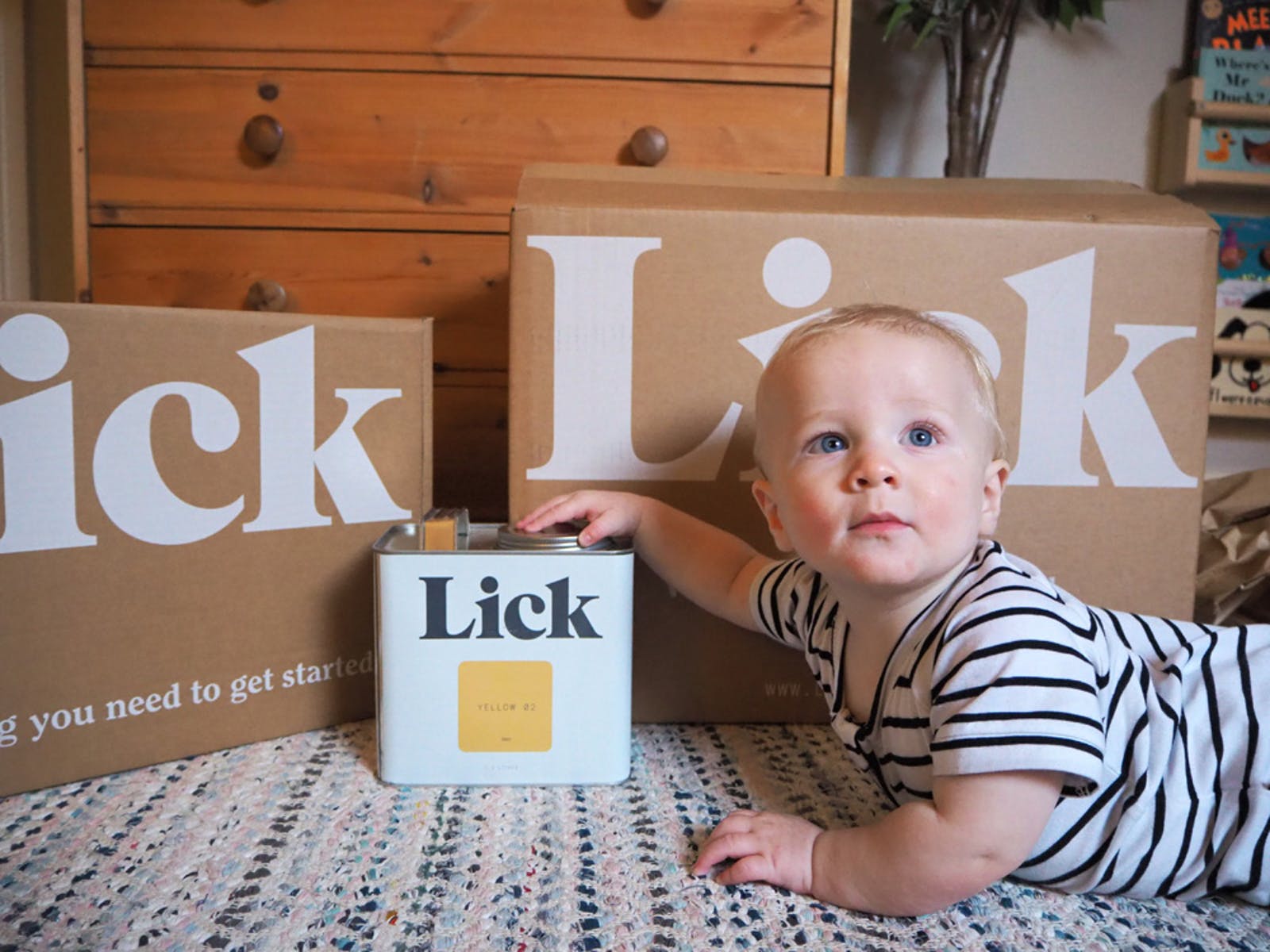 Baby in front of a Lick Yellow 02 tin courtesy of @_farley_and_me_