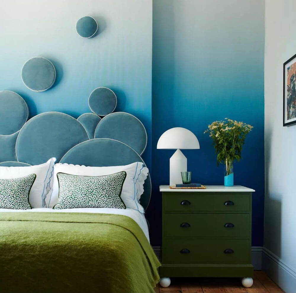 Blue circle headboard with green bedding