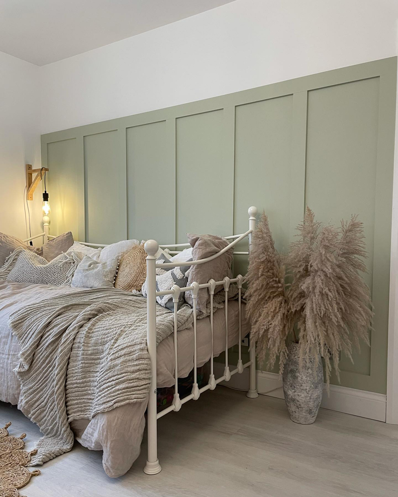 Metal day bed with jute rug and textured bedding 