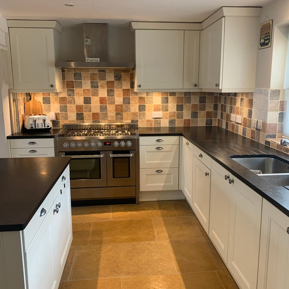 A neutral kitchen with white cabinets
