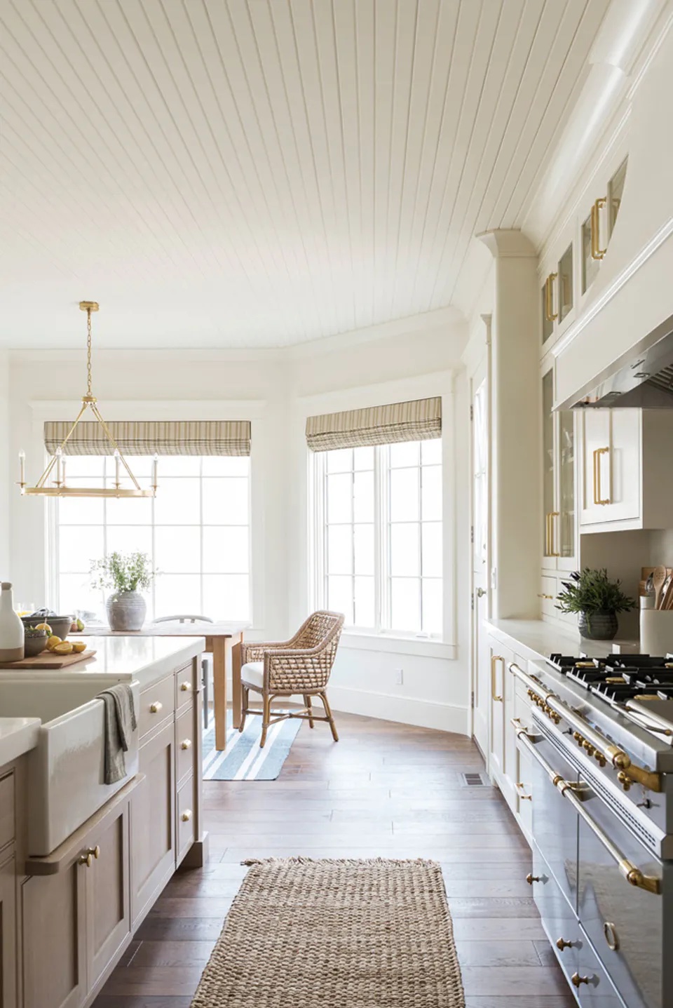 Modern farmhouse kitchen with a beige rug via Studio McGee