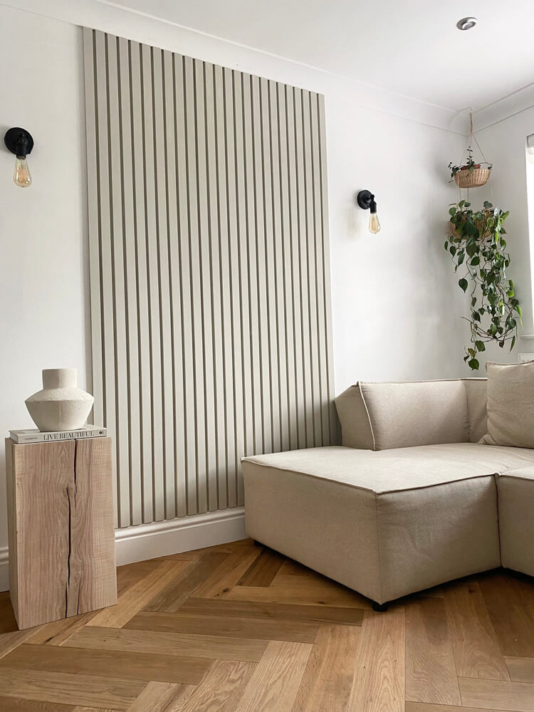 Minimalist living room with modern couch and baton panelling on wall