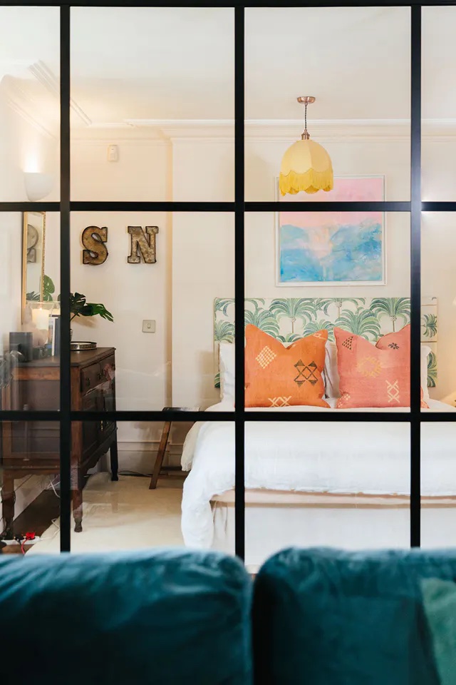 Studio apartment with a glass divider between bedroom and living room