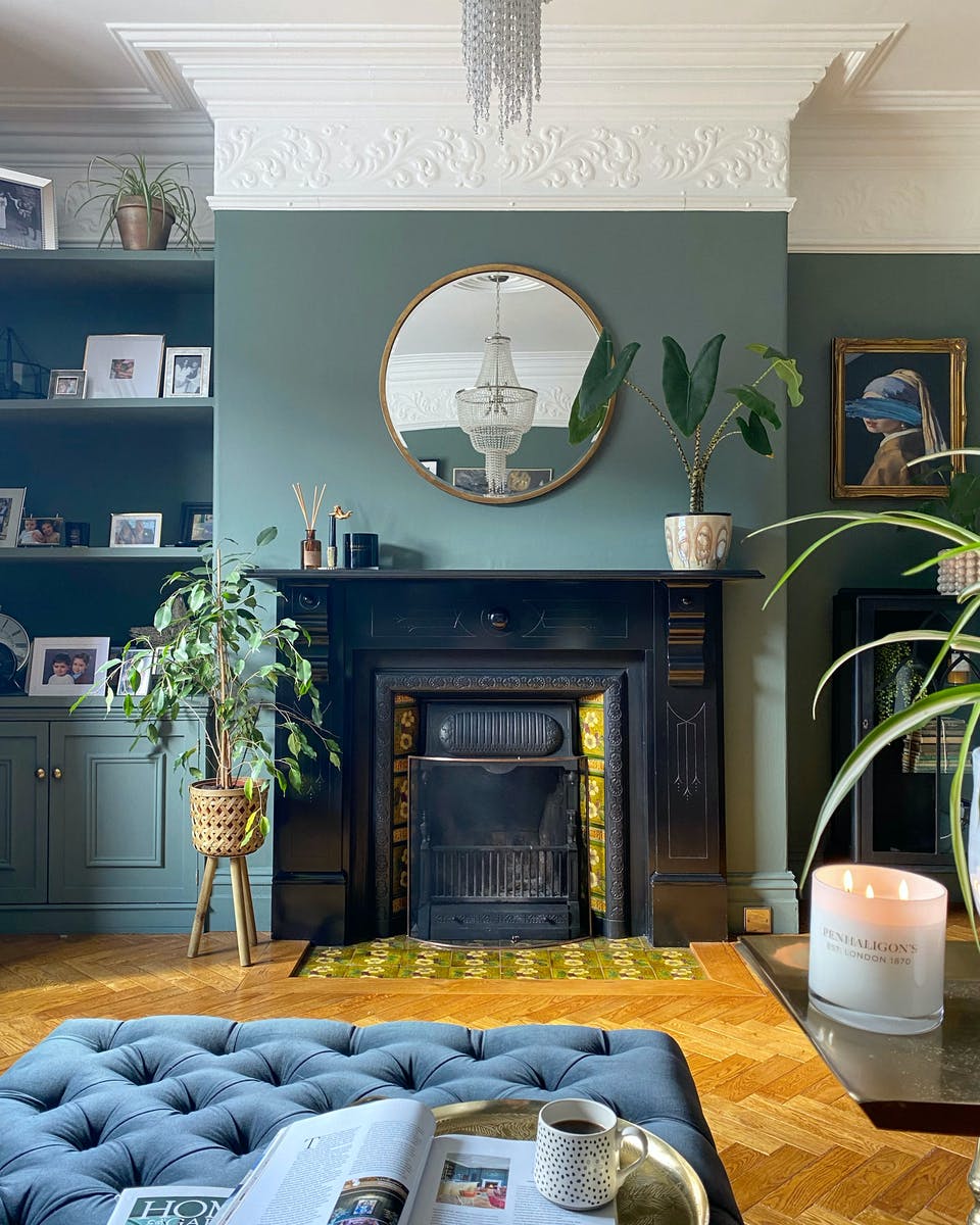 Green living room with original fireplace