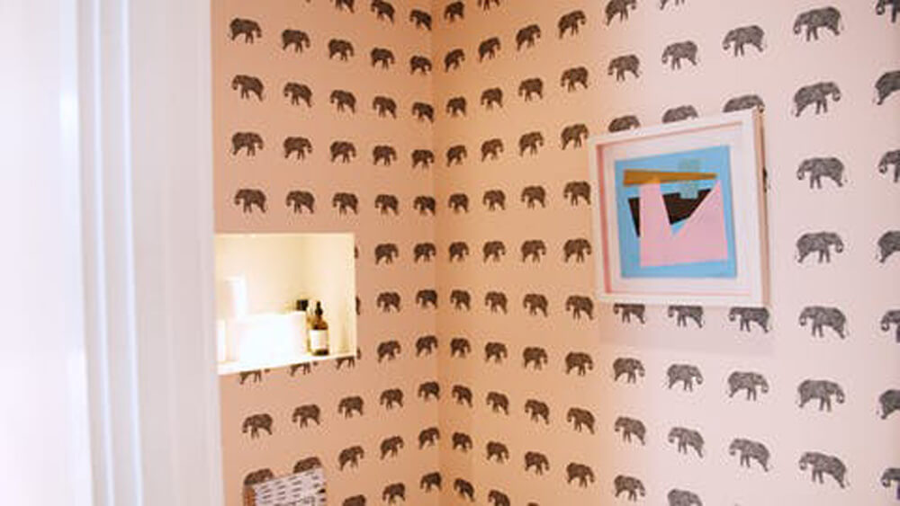 Vogue Williams' bathroom painted in Lick Pink 04 paint and Animal 04 wallpaper