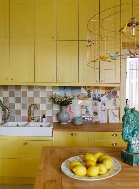 Small kitchen painted in vibrant yellow paint