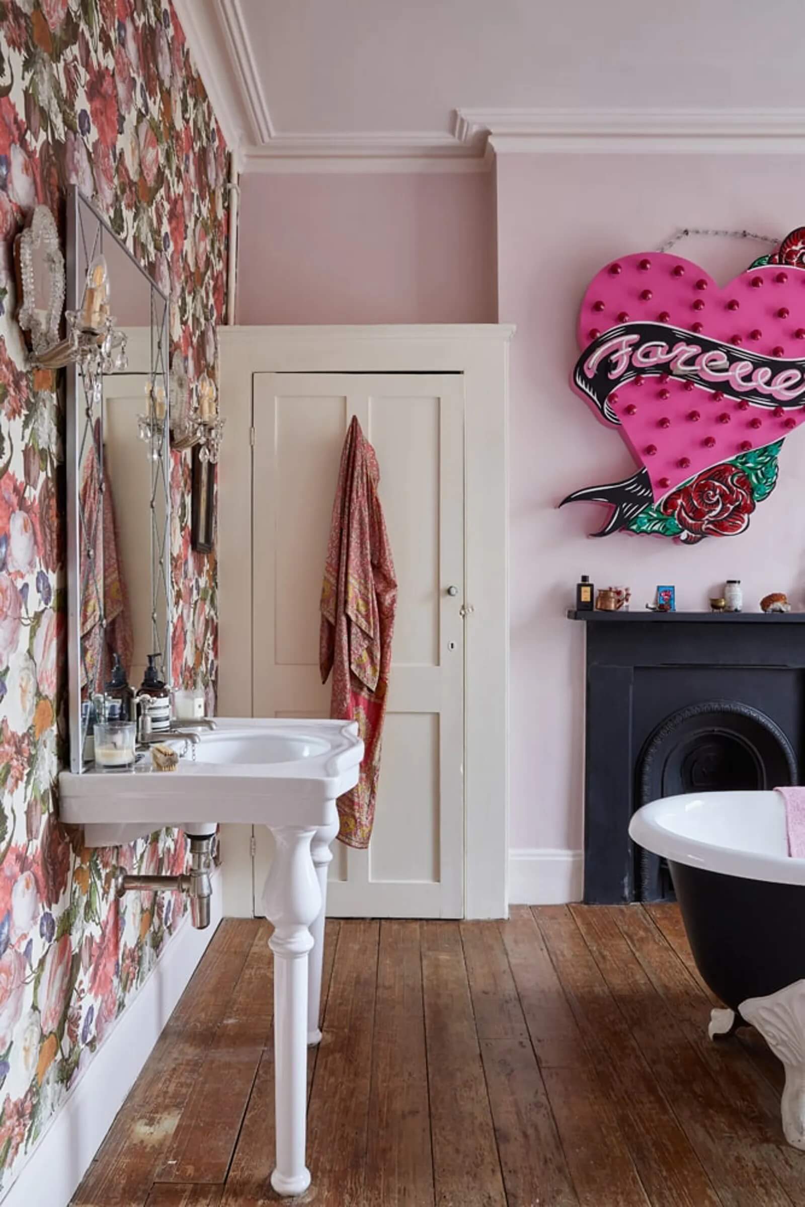Daisy Lowe's bathroom with floral wallpaper and pink walls