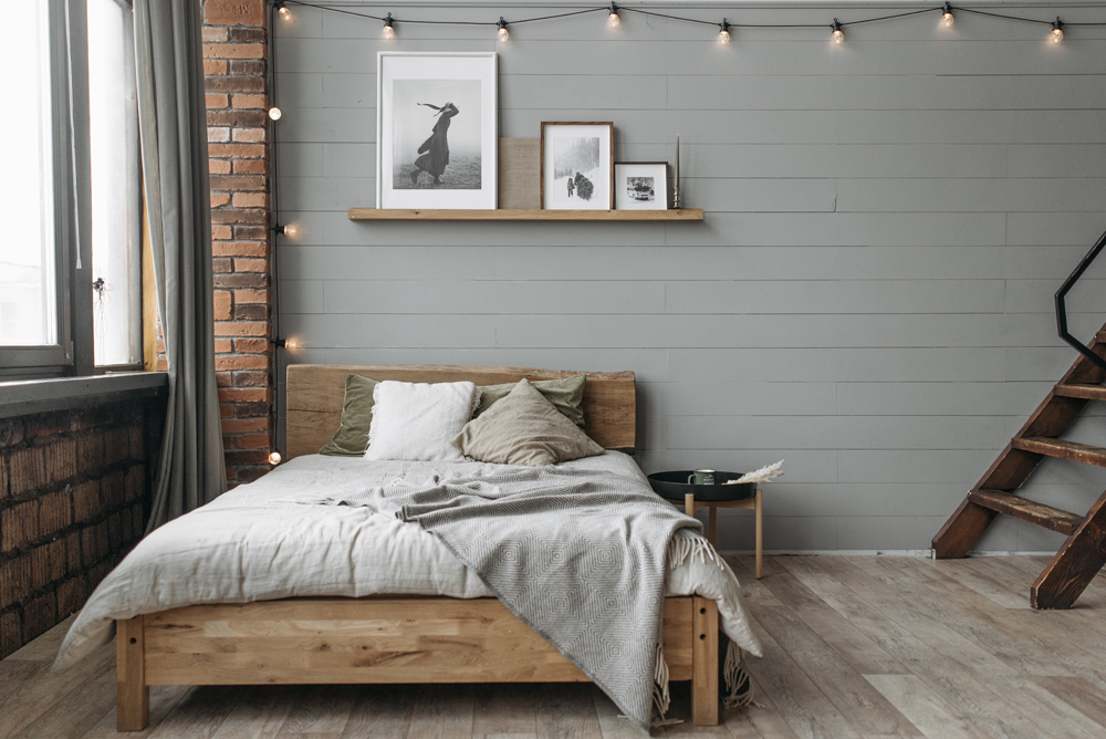 Industrial bedroom with grey wooden panel walls 