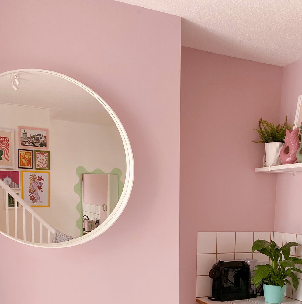Circle mirror in room painted in Lick Pink 03
