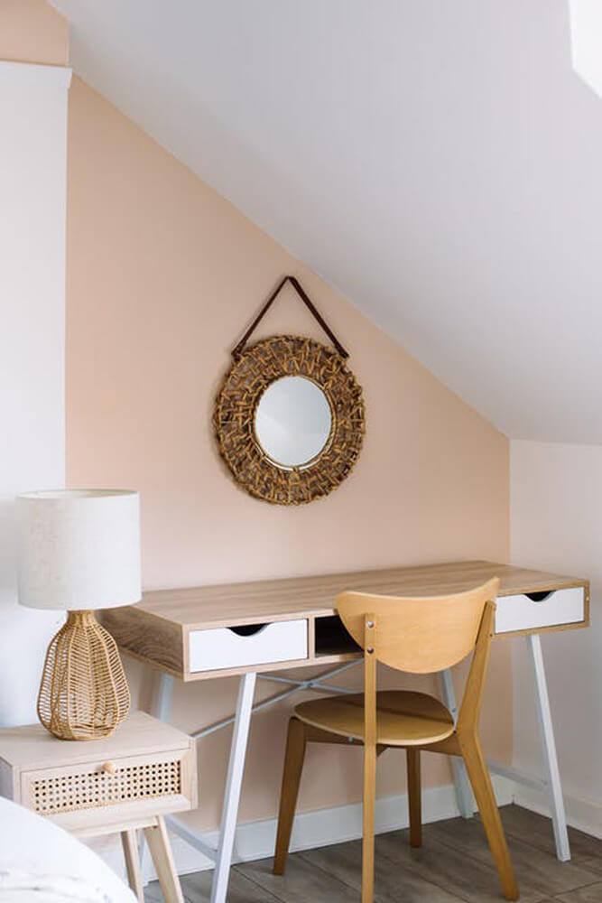 Bedroom painted in Lick Pink 02 with light wooden furniture