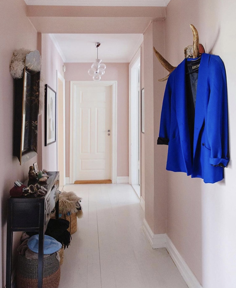 Eclectic hallway painted in light pink paint by Erica Mathiesen