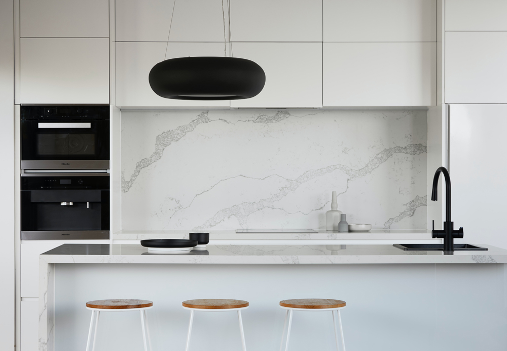 A modern kitchen with a marble splashback